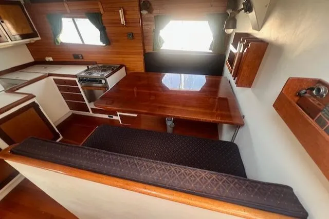 Slide: The Image of Interior of 1996 Custom Bolger PH Shoal-draft Ketch with dining area and kitchen. - 26