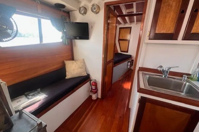 Slide: The Image of Interior of 1996 Custom Bolger PH Shoal-draft Ketch with wood finish and cozy seating. - 27