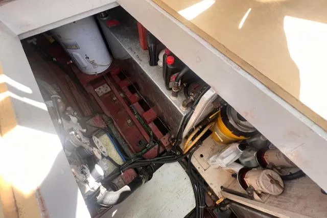Slide: The Image of Engine compartment of 1996 Custom Bolger PH Shoal-draft Ketch, showing mechanical components and wiring. - 45