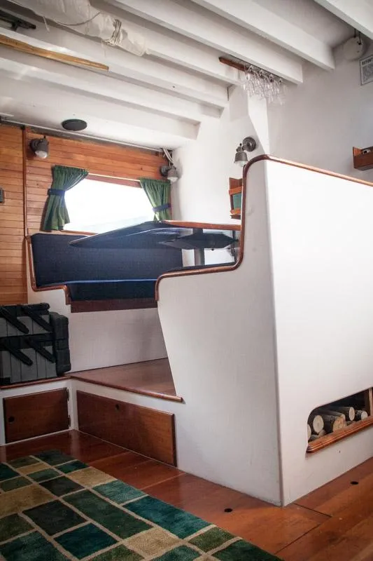 Slide: The Image of Interior of 1996 Custom Bolger PH Shoal-draft Ketch with wooden accents and nautical decor. - 5