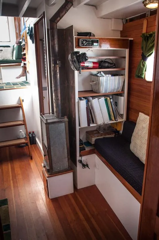 Slide: The Image of Cozy interior of 1996 Custom Bolger PH Shoal-draft Ketch with wood stove and seating area. - 8