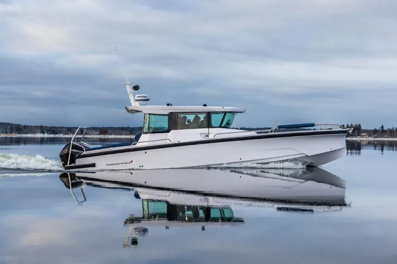 Slide: The Image of 2025 Axopar 29 XC Cross Cabin cruising on calm waters. - 0
