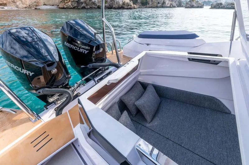 Slide: The Image of 2025 Axopar 29 XC Cross Cabin with Mercury engines, featuring a cozy seating area. - 10