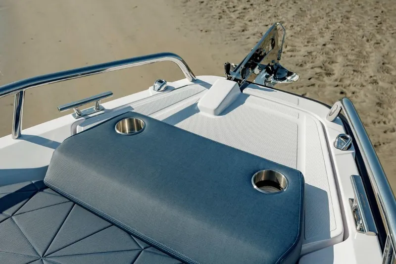 Slide: The Image of 2025 Axopar 29 XC Cross Cabin bow with cushioned seating and cup holders. - 4