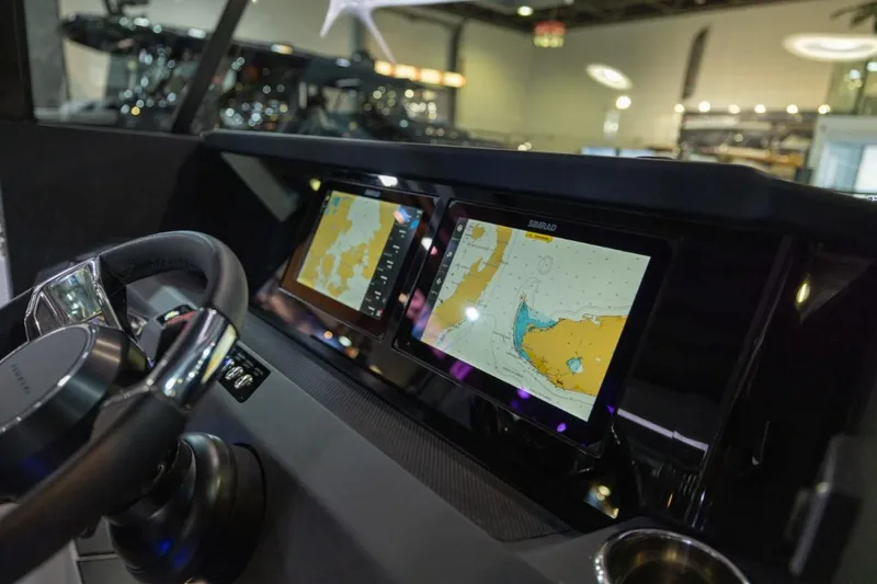 Slide: The Image of 2025 Axopar 29 XC Cross Cabin dashboard with dual navigation screens. - 6