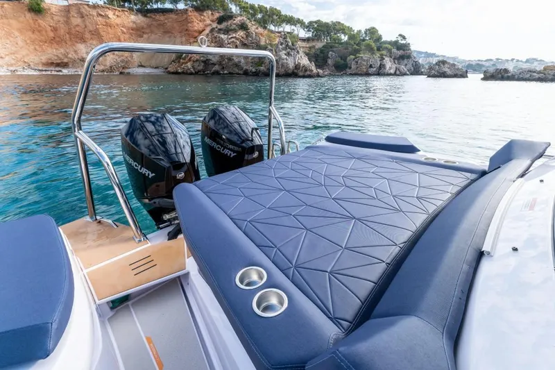 Slide: The Image of 2025 Axopar 29 XC Cross Cabin boat with dual Mercury engines on scenic water. - 9