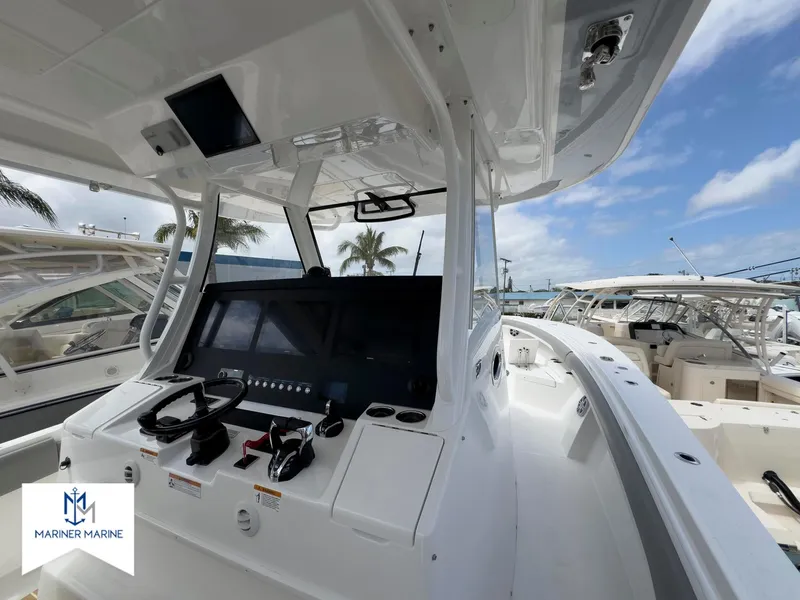 Slide: The Image of 2024 Regulator 37 boat cockpit with modern controls, docked under clear skies. - 10