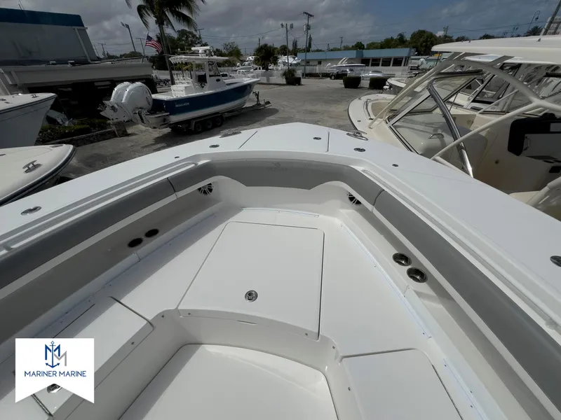 Slide: The Image of 2024 Regulator 37 boat deck at Mariner Marine dealership, showcasing spacious seating and storage. - 13