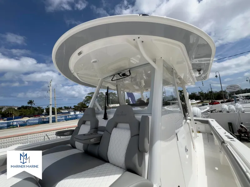 Slide: The Image of 2024 Regulator 37 boat with sleek design and comfortable seating under a clear blue sky. - 15