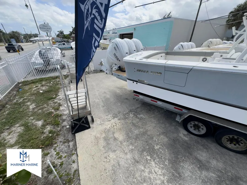 Slide: The Image of 2024 Regulator 37 boat on trailer at Mariner Marine dealership. - 2