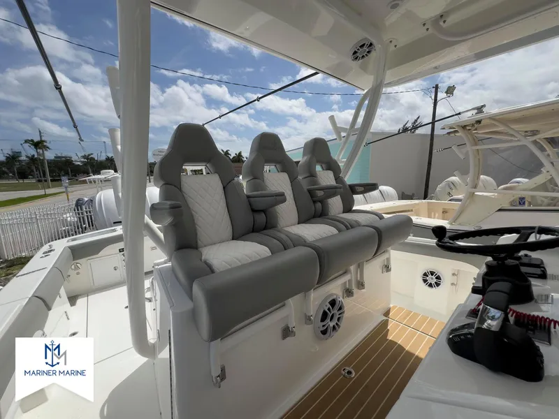 Slide: The Image of 2024 Regulator 37 boat interior with three cushioned seats and modern controls. - 26