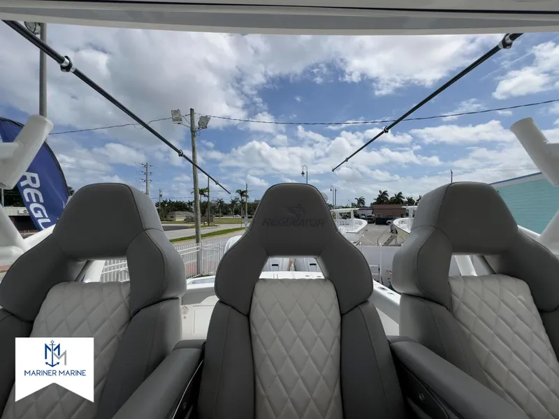 Slide: The Image of 2024 Regulator 37 boat seats with quilted design under a cloudy sky. - 27