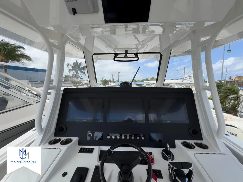 Slide: The Image of 2024 Regulator 37 boat cockpit with advanced navigation system and steering wheel. - 28
