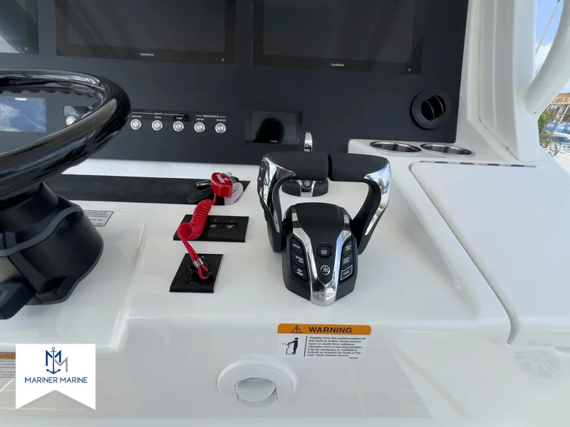 Slide: The Image of 2024 Regulator 37 boat helm with steering wheel, controls, and digital displays. - 30