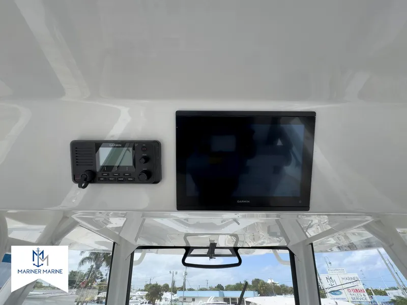 Slide: The Image of 2024 Regulator 37 boat interior with navigation screen and radio system. - 33