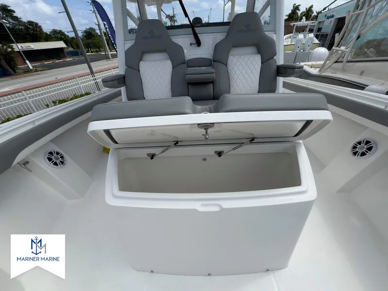 Slide: The Image of 2024 Regulator 37 boat with open storage compartment and dual seats, Mariner Marine logo visible. - 37