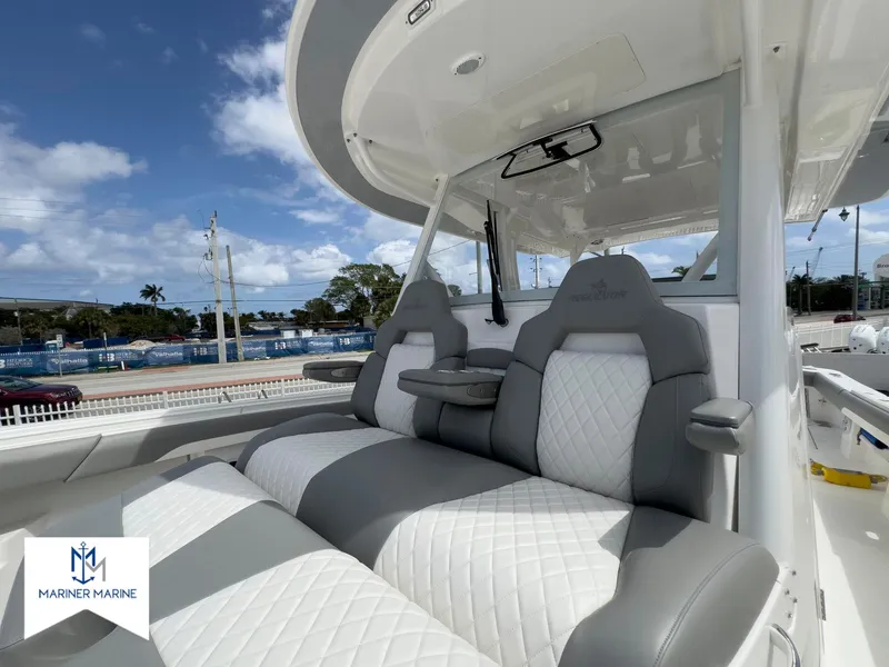 Slide: The Image of 2024 Regulator 37 boat with luxurious gray and white seating, showcased at Mariner Marine. - 39