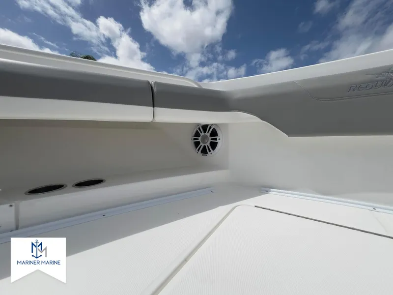 Slide: The Image of 2024 Regulator 37 boat interior with speaker, sleek design, and Mariner Marine logo. - 40