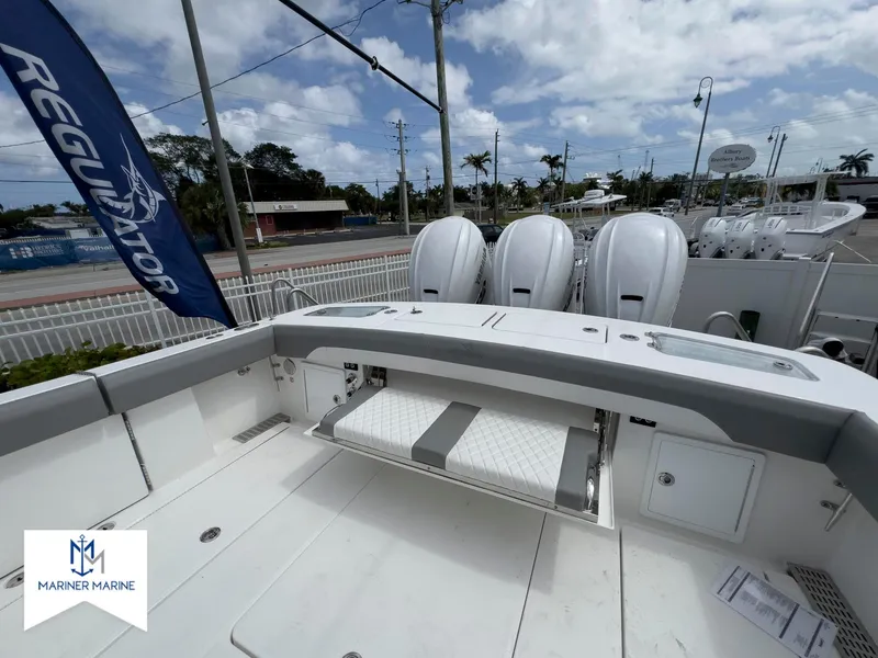 Slide: The Image of 2024 Regulator 37 boat deck with triple outboard engines, Mariner Marine branding. - 42