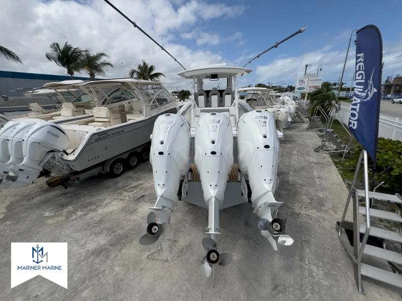 Slide: The Image of 2024 Regulator 37 boat with triple outboard engines at Mariner Marine dealership. - 45