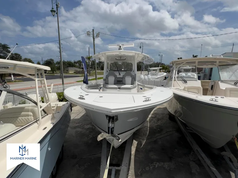 Slide: The Image of 2024 Regulator 37 boat displayed at Mariner Marine dealership under a cloudy sky. - 46