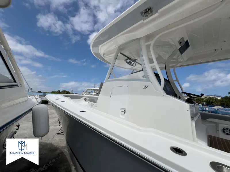 Slide: The Image of 2024 Regulator 37 boat docked under a clear blue sky at Mariner Marine. - 5