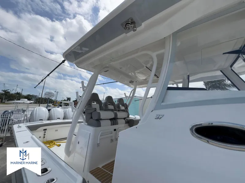 Slide: The Image of 2024 Regulator 37 boat with seating, under a cloudy sky at Mariner Marine. - 7