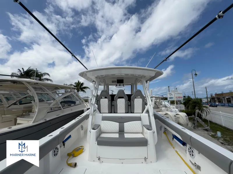 Slide: The Image of 2024 Regulator 37 boat interior with seating, under a partly cloudy sky. - 9