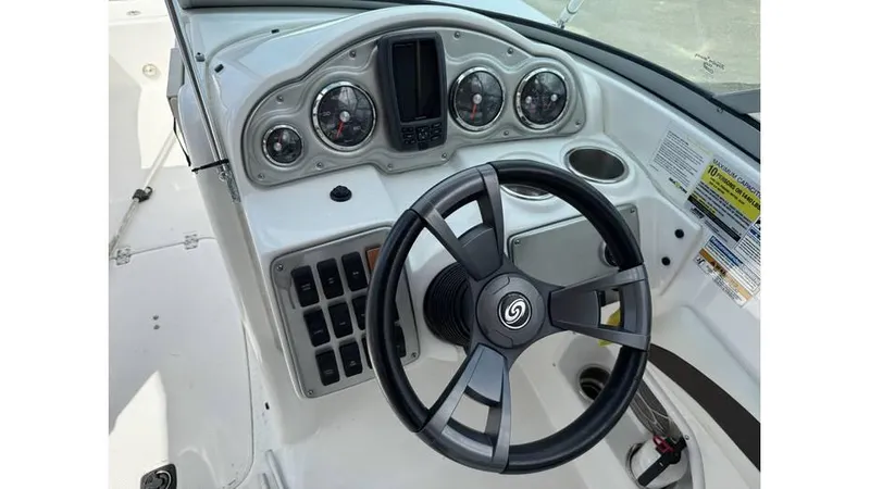Slide: The Image of 2015 Hurricane SunDeck 2200 DC OB boat dashboard with steering wheel and gauges. - 2