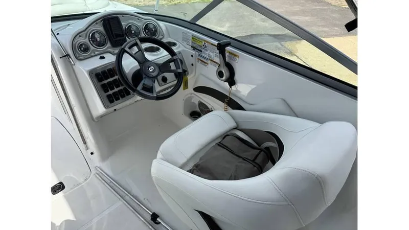 Slide: The Image of 2015 Hurricane SunDeck 2200 DC OB boat cockpit with steering wheel and captain's chair. - 3