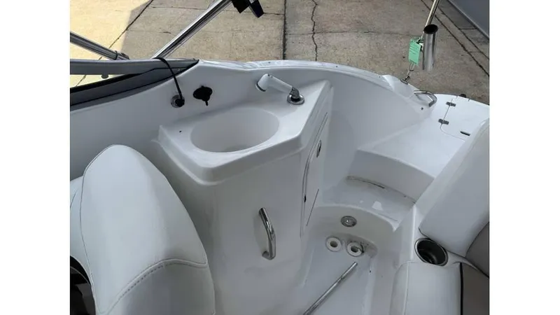 Slide: The Image of 2015 Hurricane SunDeck 2200 DC OB boat interior with sink and seating. - 4