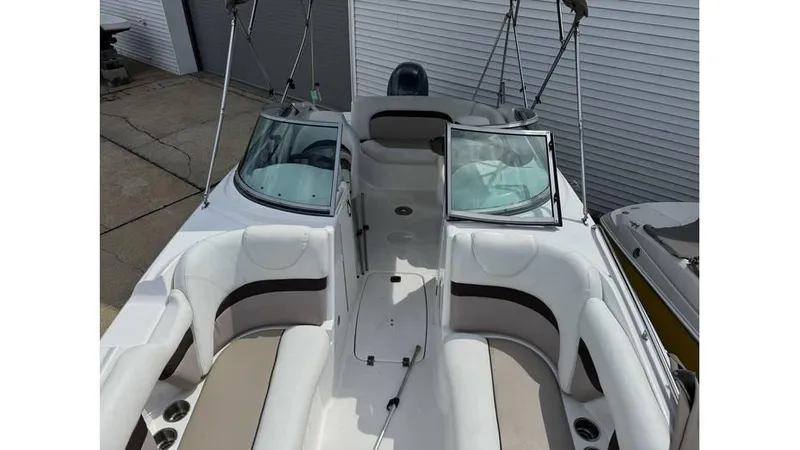 Slide: The Image of 2015 Hurricane SunDeck 2200 DC OB boat interior with white and beige seating. - 9