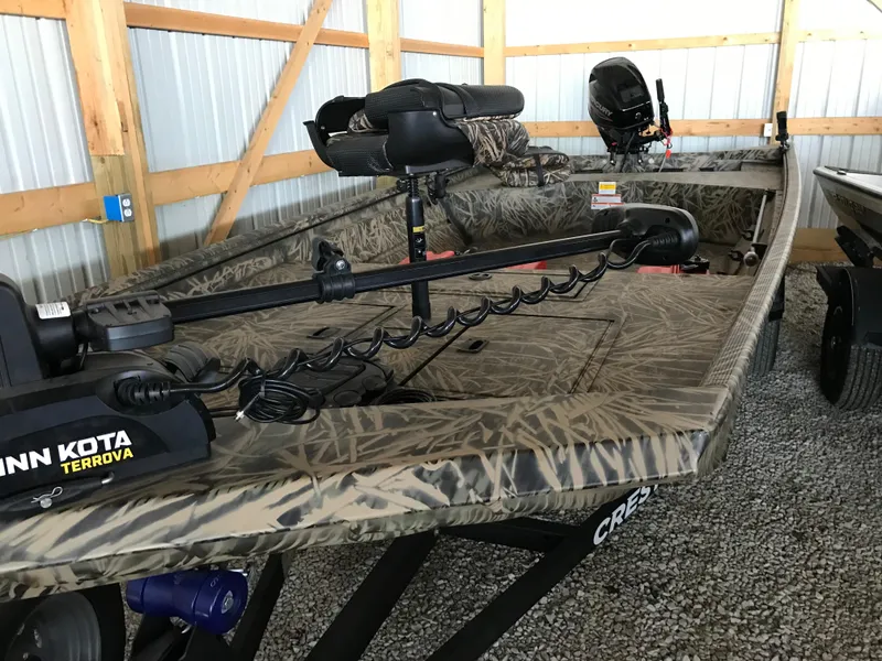 Slide: The Image of 2022 Crestliner 1760 Retriever Jon boat with Minn Kota Terrova trolling motor in storage. - 10
