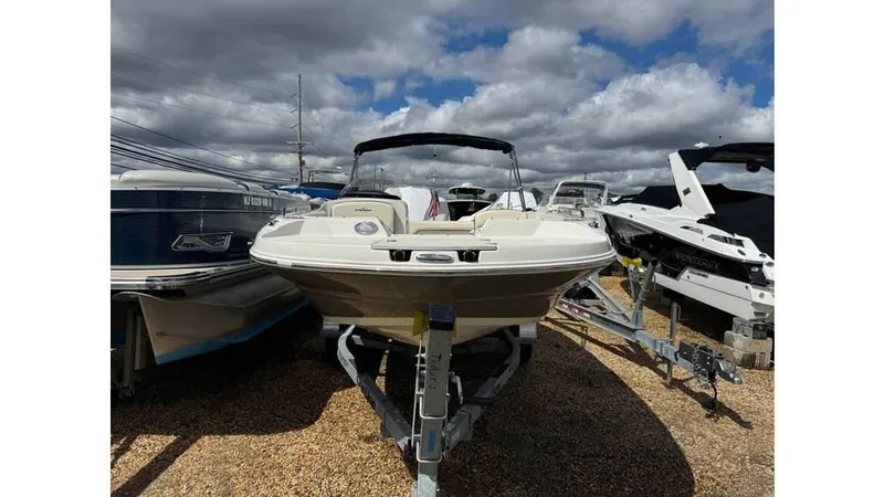 The Image of 2022 Stingray 192 SC boat on trailer under cloudy sky. - 0