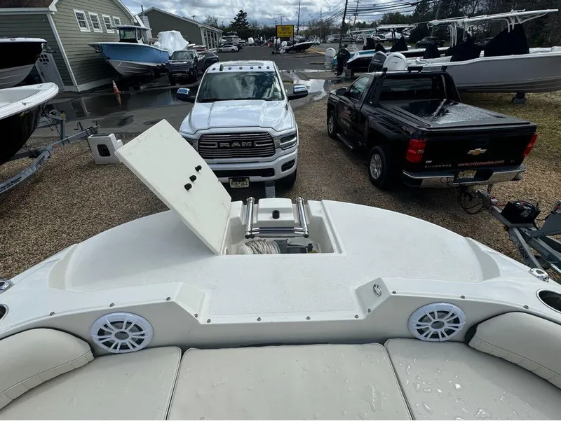 Slide: The Image of 2022 Stingray 192 SC boat on trailer, surrounded by trucks and other boats. - 4
