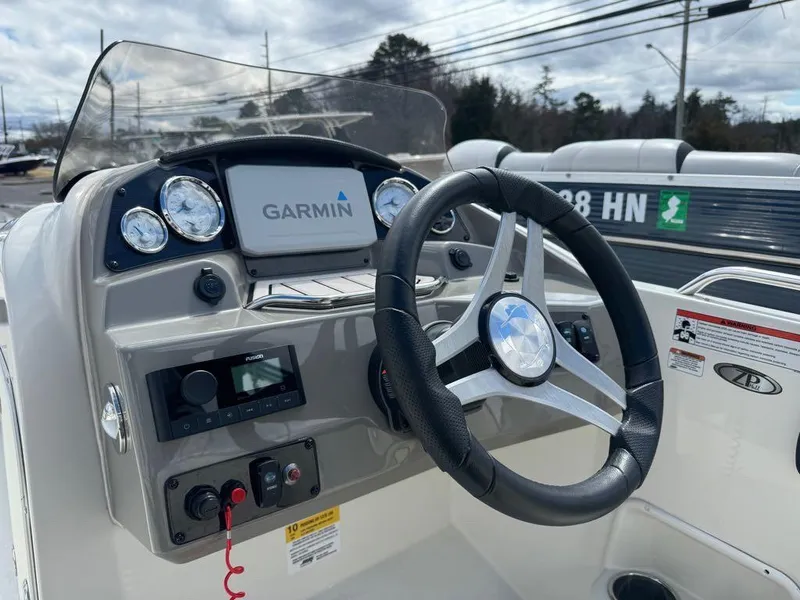 Slide: The Image of 2022 Stingray 192 SC boat dashboard with Garmin navigation system and steering wheel. - 7