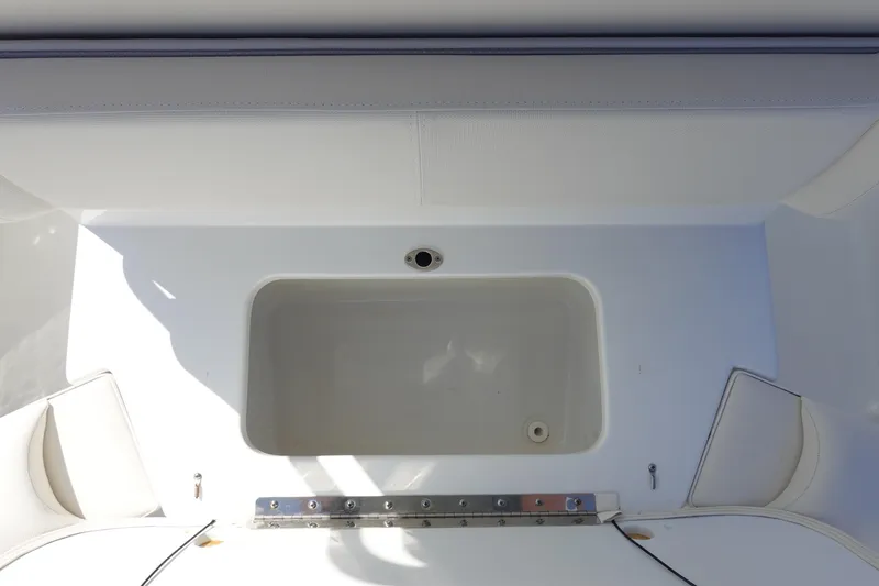 Slide: The Image of 2025 Sea Hunt Ultra 239 SE boat seat with white cushioned design. - 13