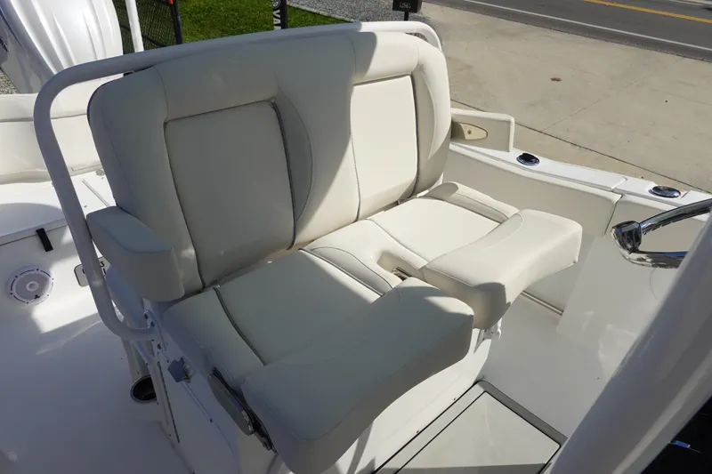 Slide: The Image of 2025 Sea Hunt Ultra 239 SE boat console with steering wheel and controls. - 16