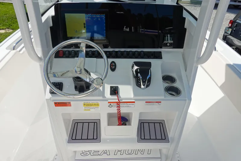 Slide: The Image of 2025 Sea Hunt Ultra 239 SE dashboard with Garmin navigation system and control panel. - 18