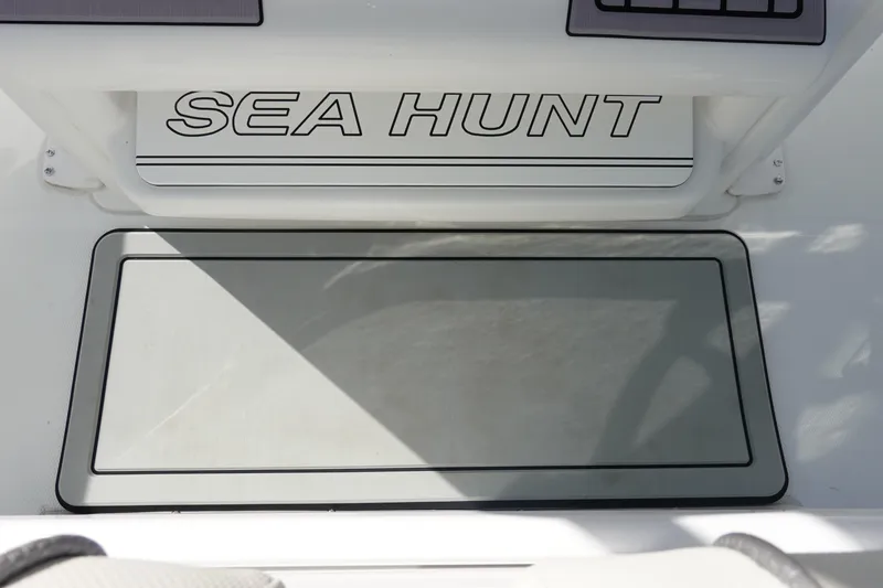 Slide: The Image of 2025 Sea Hunt Ultra 239 SE dashboard with Garmin device and control panel. - 19