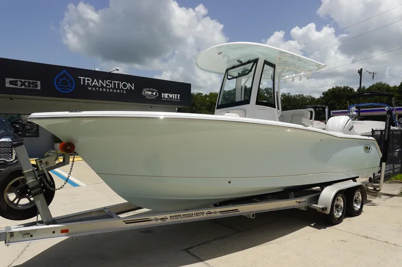 Slide: The Image of 2025 Sea Hunt Ultra 239 SE boat on trailer, parked outdoors. - 2