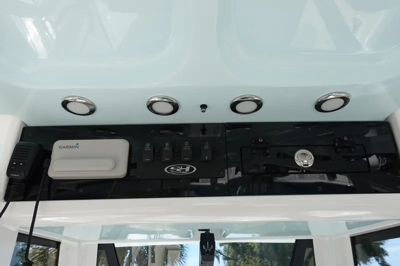 Slide: The Image of 2025 Sea Hunt Ultra 239 SE boat storage compartment with open lid. - 21