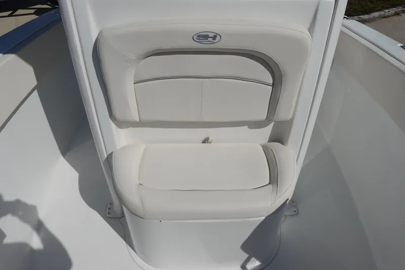 Slide: The Image of 2025 Sea Hunt Ultra 239 SE boat interior with white seating and fishing rod holders. - 22