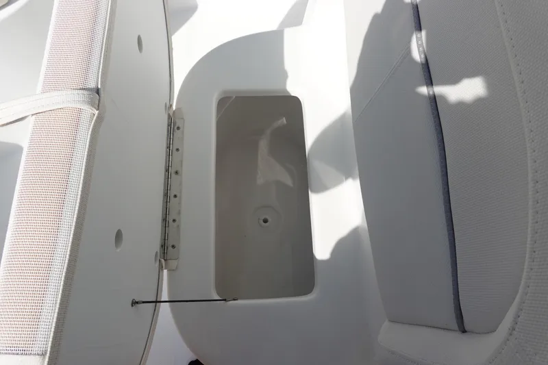 Slide: The Image of 2025 Sea Hunt Ultra 239 SE boat interior with cushioned seating and Garmin equipment. - 23