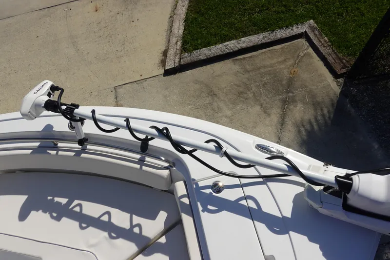 Slide: The Image of 2025 Sea Hunt Ultra 239 SE boat compartment with latch and hinges, shadowed surface. - 26