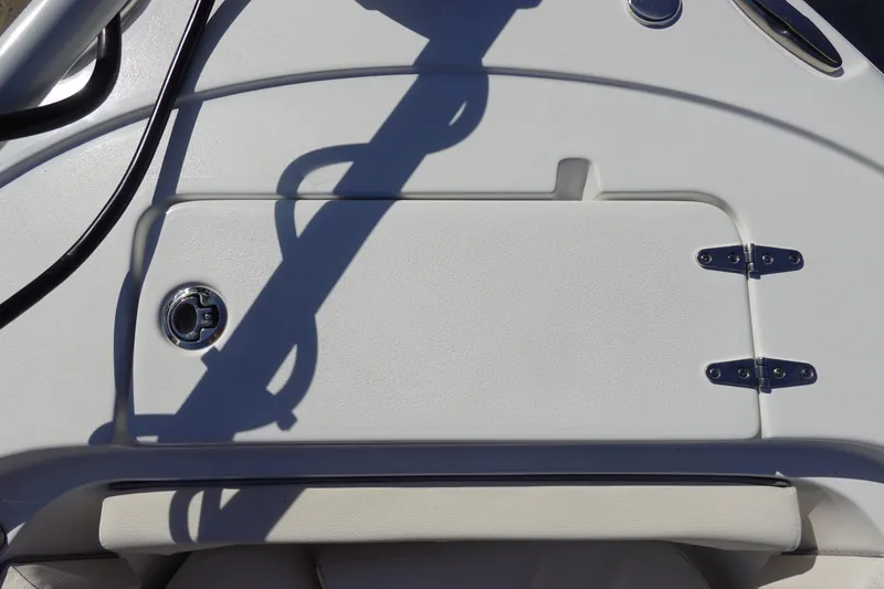 Slide: The Image of 2025 Sea Hunt Ultra 239 SE boat interior with toilet and fire extinguisher. - 28