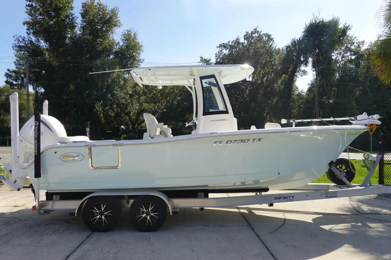 Slide: The Image of 2025 Sea Hunt Ultra 239 SE boat on trailer, parked outdoors. - 3