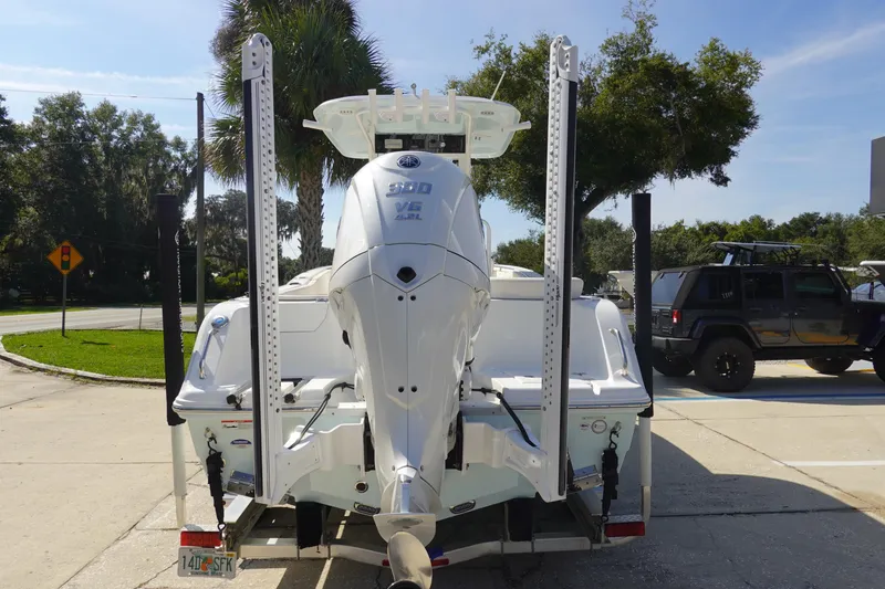 Slide: The Image of 2025 Sea Hunt Ultra 239 SE boat with white cushioned seating and Yamaha engine. - 6