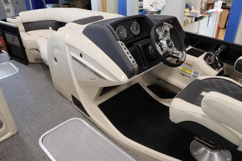 Slide: The Image of 2025 Barletta Lusso 23U boat interior with luxurious seating and modern dashboard. - 10