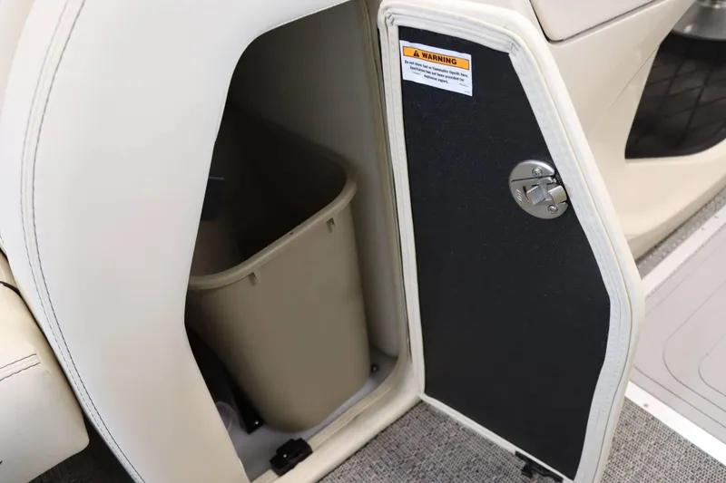 Slide: The Image of Barletta Lusso 23U 2025 storage compartment with trash bin and warning label. - 15